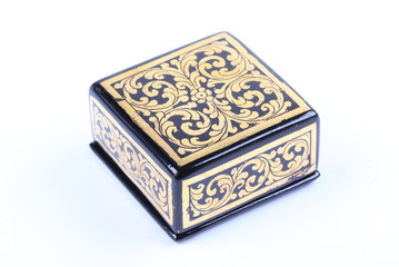 Vintage golden lacquer box on white background.