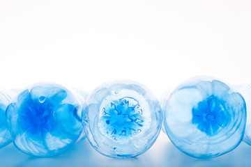 Top view of plastic bottles bottoms on white background