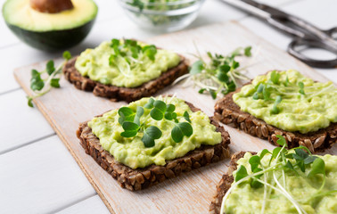Fresh wholegrain toasts with avocado and microgreens