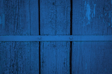 Old weathered wooden plank on toning in classic blue color, creative design of 2020, wooden texture wall background