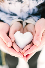 Fototapeta premium Snowy heart in hands. Christmas background
