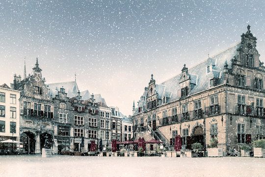 Snow view of the central historic square with bars and restaurants in the ancient Dutch city center of Nijmegen