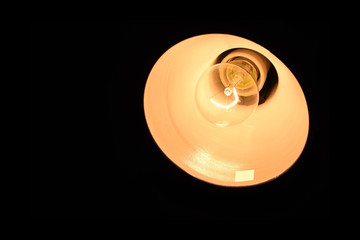 light bulb on a black background with a burning spiral