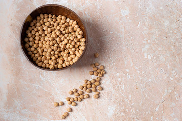 Vegetarian food. chickpeas in an organic bowl made of natural material on a marble background. Top view image