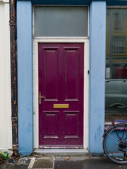 Fototapeta na wymiar View of a magenta color door, Ennistimon, County Clare, Ireland