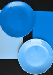 Abstract photo of blue plates on dark background.