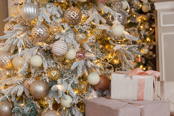 Christmas tree with lots of toys and Christmas lights with gifts under the tree