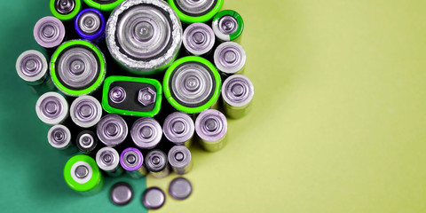 Many different types used or new battery, rechargeable accumulator, alkaline batteries on color...