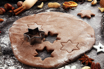 Baking christmas cookies. Typical cinnamon stars bakery with spices. xmas decoration on table