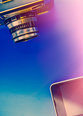 mobile phone and film camera lie on a blue background.