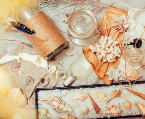 Plakat a lot of sea theme in mess like shells, candles, perfume, girl stuff on linen, pretty textured post card view vintage close up