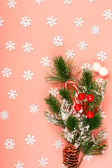 Christmas pink background. Snowflakes. Spruce branch, bump. Lollipop. Red berries.