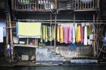 Colourful washing hangs from a traditional wooden building, Fenghuang, China