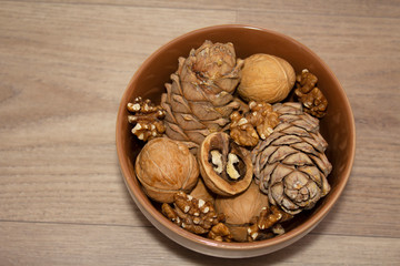  different nuts in a cup on a wooden background