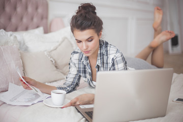 Young attractive woman working at laptop