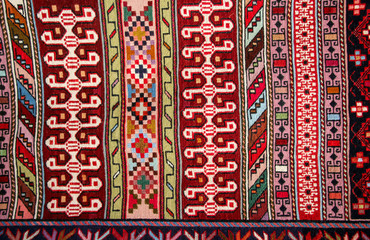 Old traditional carpet with a geometric pattern blue, white and dark red colors in arabic style on...