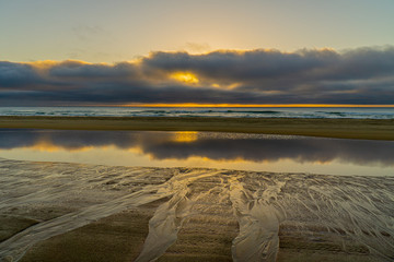 the beach of Fraser Island you can see a beautiful sunrise like in paradise