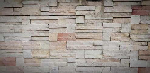 Pattern of rough brick wall for background in vintage tone. Art wallpaper and Architecture Exterior design concept 