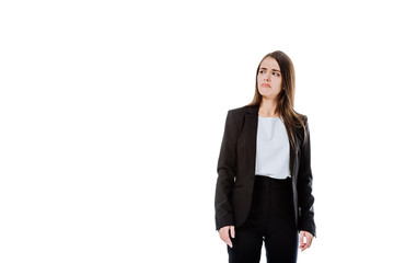 Obraz premium dissatisfied businesswoman in suit looking away isolated on white