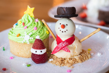 Christmas cupcakes with decoration. snowman with winter spices for Christmas