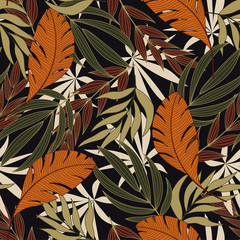 Abstract seamless tropical pattern with bright orange and green plants and leaves on dark background. Jungle leaf seamless vector floral pattern background. Beautiful seamless vector floral pattern.