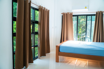 Beige curtain in cozy white bedroom