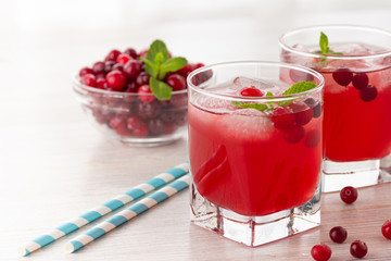 Red coctail with cranberry, vodka and ice. Refreshment drink.