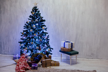 Christmas tree with lights light Garland and gifts for the new year