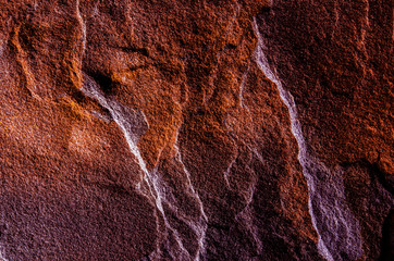 A natural background made of multi-colored wild stone close-up. View from above