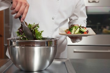 Chef Preparing Leaf Vegetables In Commercial Kitchen