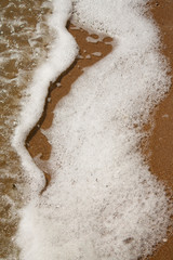 foam from water after surf on the estuary