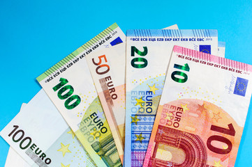 Money euro banknotes on a blue background, top view