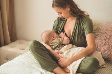 The concept of breastfeeding. Portrait of mom and breastfeeding baby. 