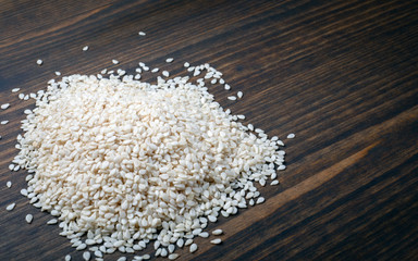 Organic natural sesame seeds on wooden table