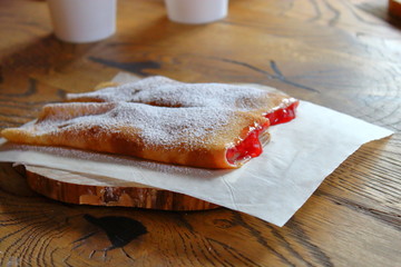 Slapjack pancakes on a wooden table.