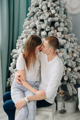 young beautiful couple near new year tree