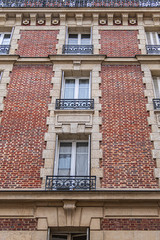 Obraz premium Old French house with traditional balconies and windows. Paris, France.