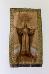 Embroidered fabric with the image of the Virgin Mary hanging on the wall in the Our Lady of the Ark of the Covenant Church in the Chechen village Abu Ghosh near Jerusalem in Israel