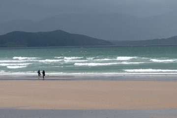 Fototapeta na wymiar Hikers on beach of beach, Castlegregory, County Kerry, Ireland