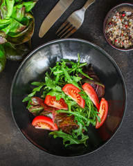 Healthy salad, tomato, leaves mix salad (mix micro greens, onion, other ingredients). food background. copy space