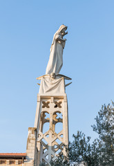 Statue of the Mother of God with a baby in her arms on the roof of the Our Lady of the Ark of the Covenant Church in the Chechen village Abu Ghosh near Jerusalem in Israel