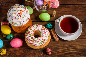 Easter cake and colorful eggs on a dark background