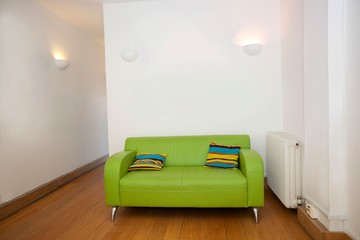 Cushions on green sofa in empty office