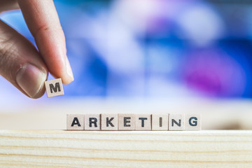 Marketing and business concept: Close up picture of wood cubes with the word “marketing”