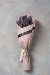 One small bouquet of lavender on a light concrete background.