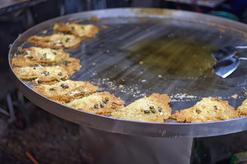 Street food in thailand fried fish-paste balls in pan.