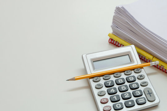 Top view and close up of calculator, yellow pencil and many documents on white table, business or financial concept.