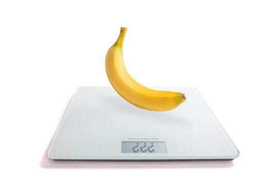 Banana On The Scales. The Concept Of Losing Weight.