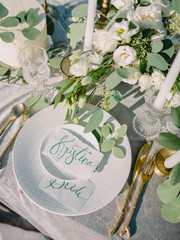 Wedding table with decorations, wedding cake, calligraphy and floristics.