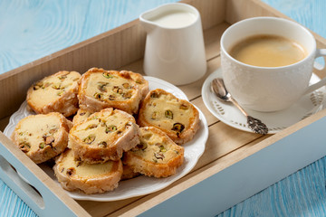 Homemade pistachio butter cookies and cup of coffee.